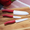Picture of Revolution 3-Piece Ceramic Knife Set - 6" Chefs, 5" Micro Serrated Tomato and 3" Paring -  Red